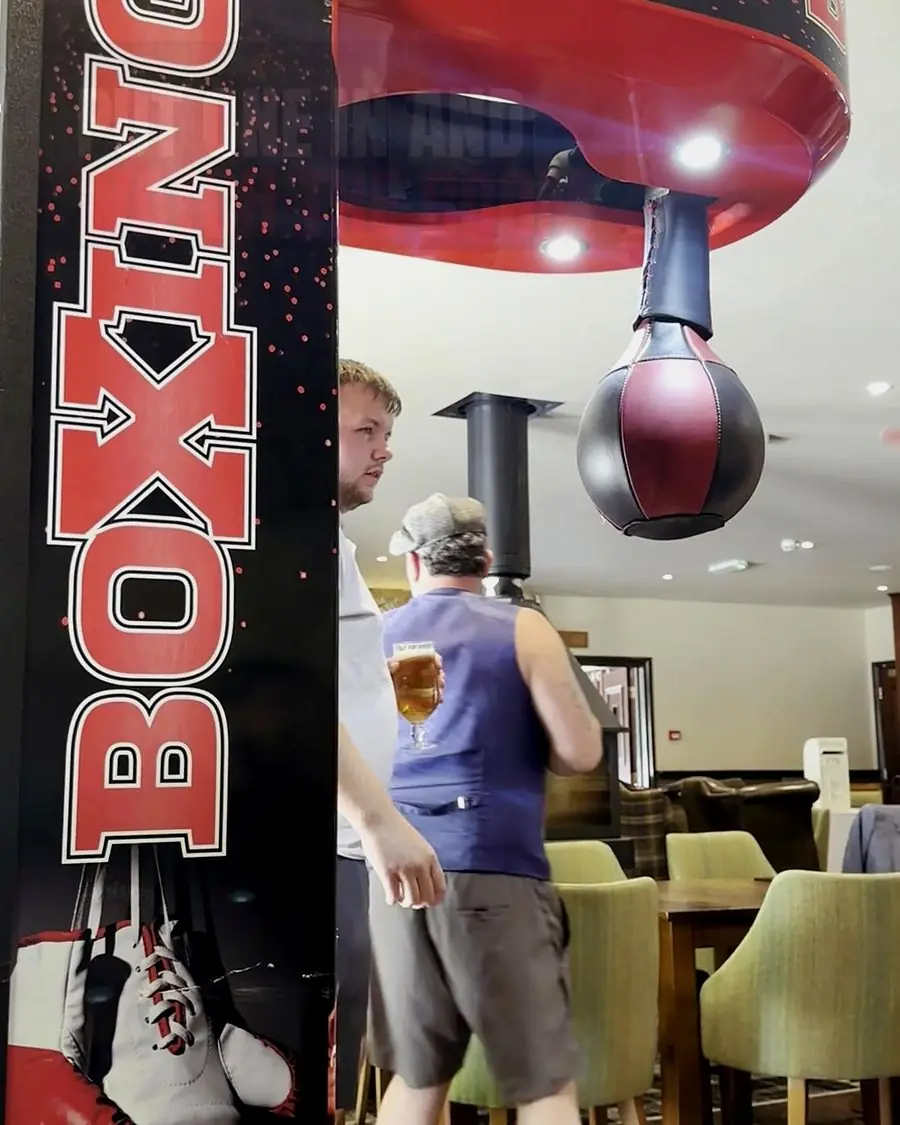 Punchbag and score display on a Haymaker boxing machine in a bar
