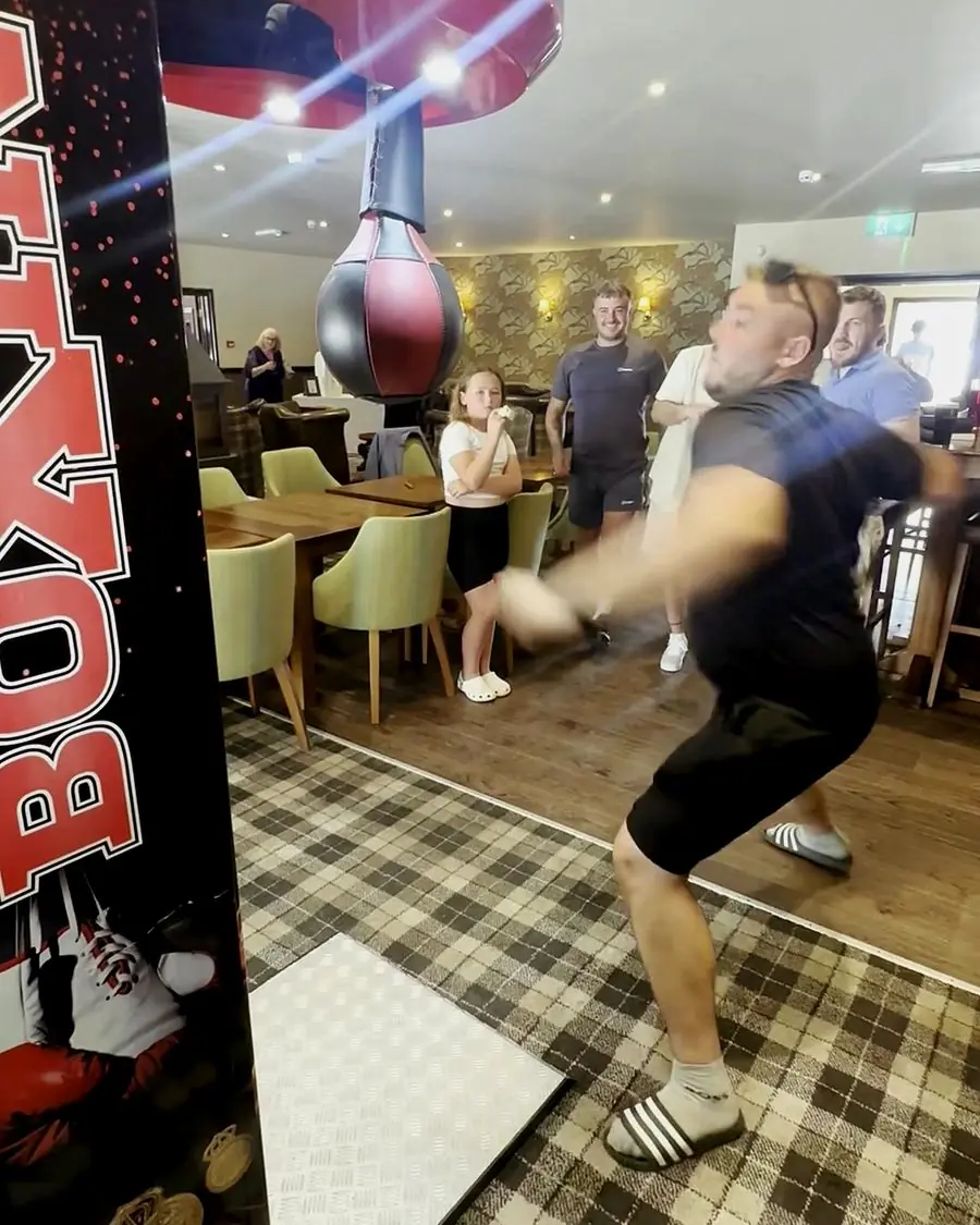 Customer punching the machine in a busy pub